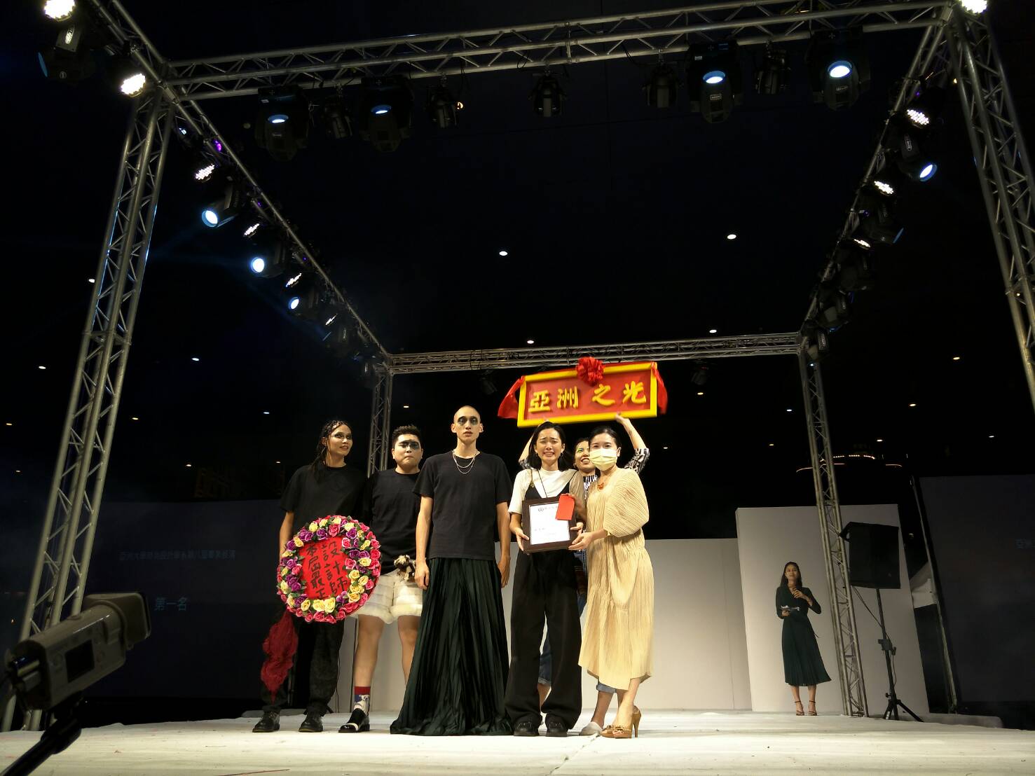 亞大時尚系主任林青玫（右一），頒獎給以「墬入牠的世界」榮獲第一名郭庭瑋同學（右二）。
