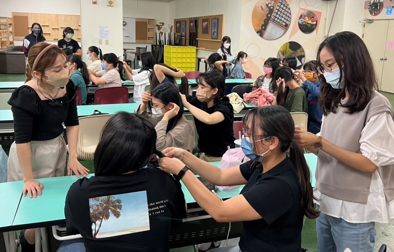 圖為在亞大惜福書苑的造型編髮課程，參與同學學習編髮技巧，相互練習。