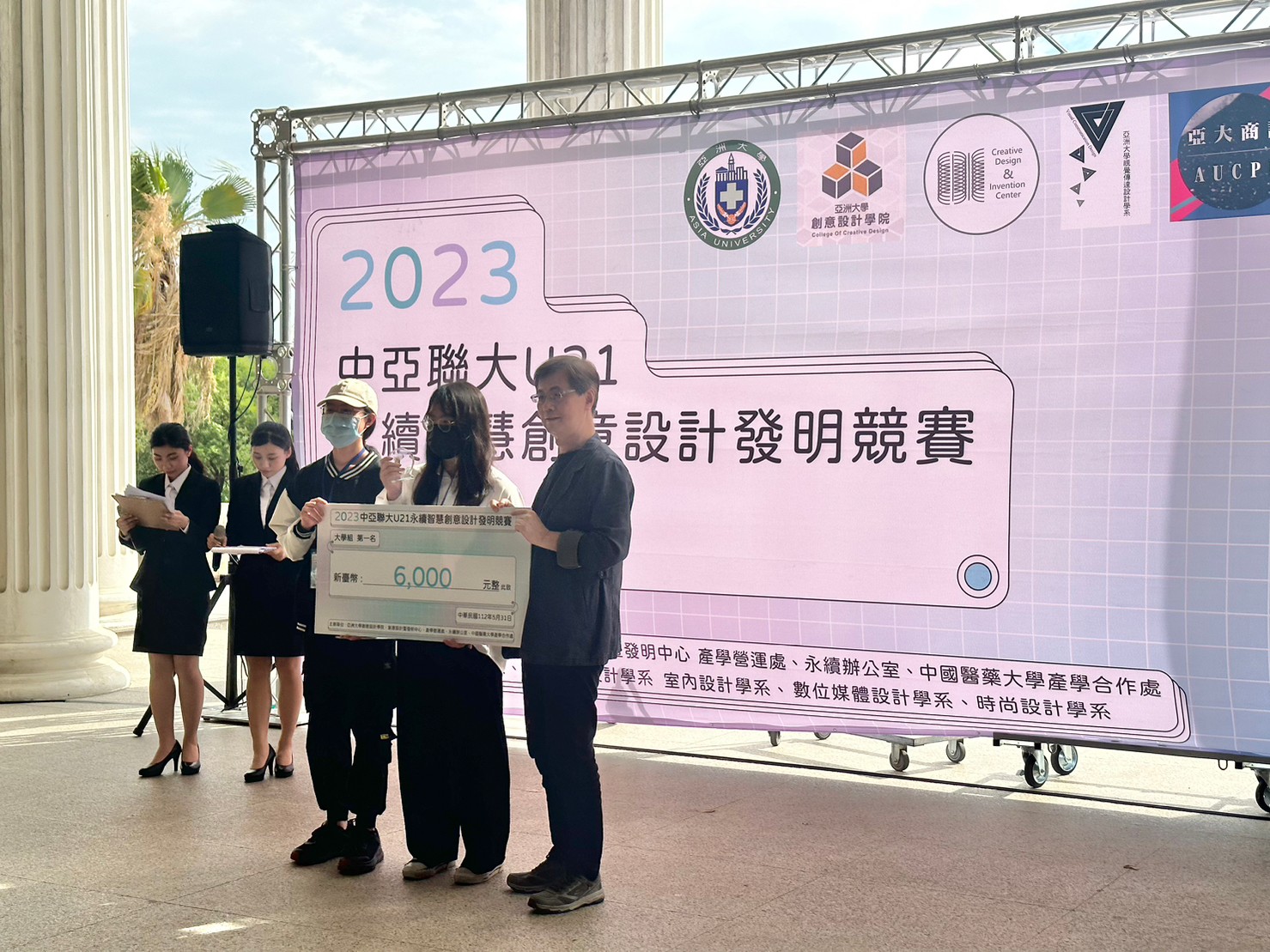 圖為亞大副校長鄧成連(右1)，頒獎給獲大學組第1名的亞大商設系同學。