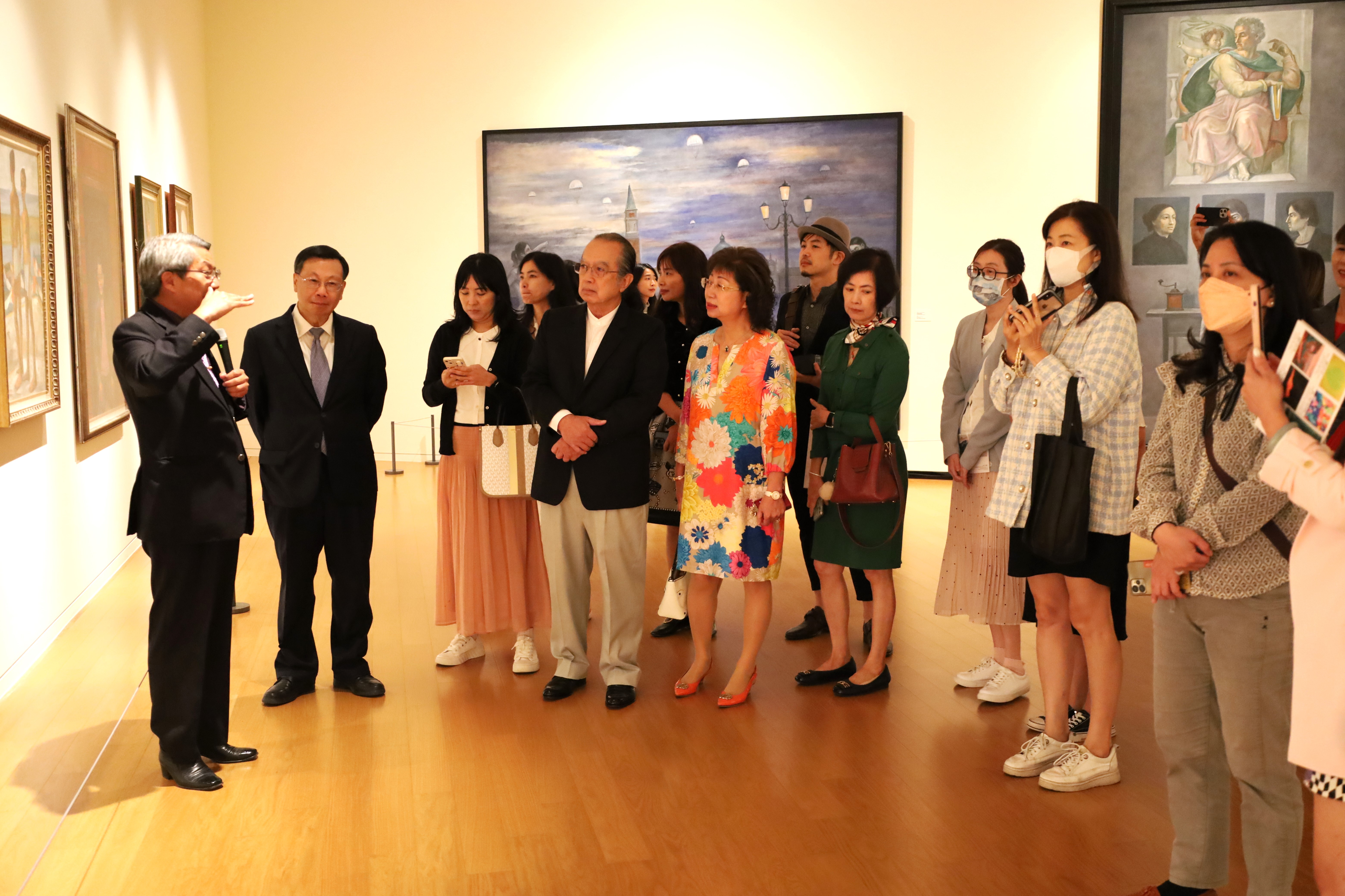 圖為亞大現代美術館長潘襎(左1)，為亞大校長蔡進發(左2)和參觀來賓，導覽特展畫作。