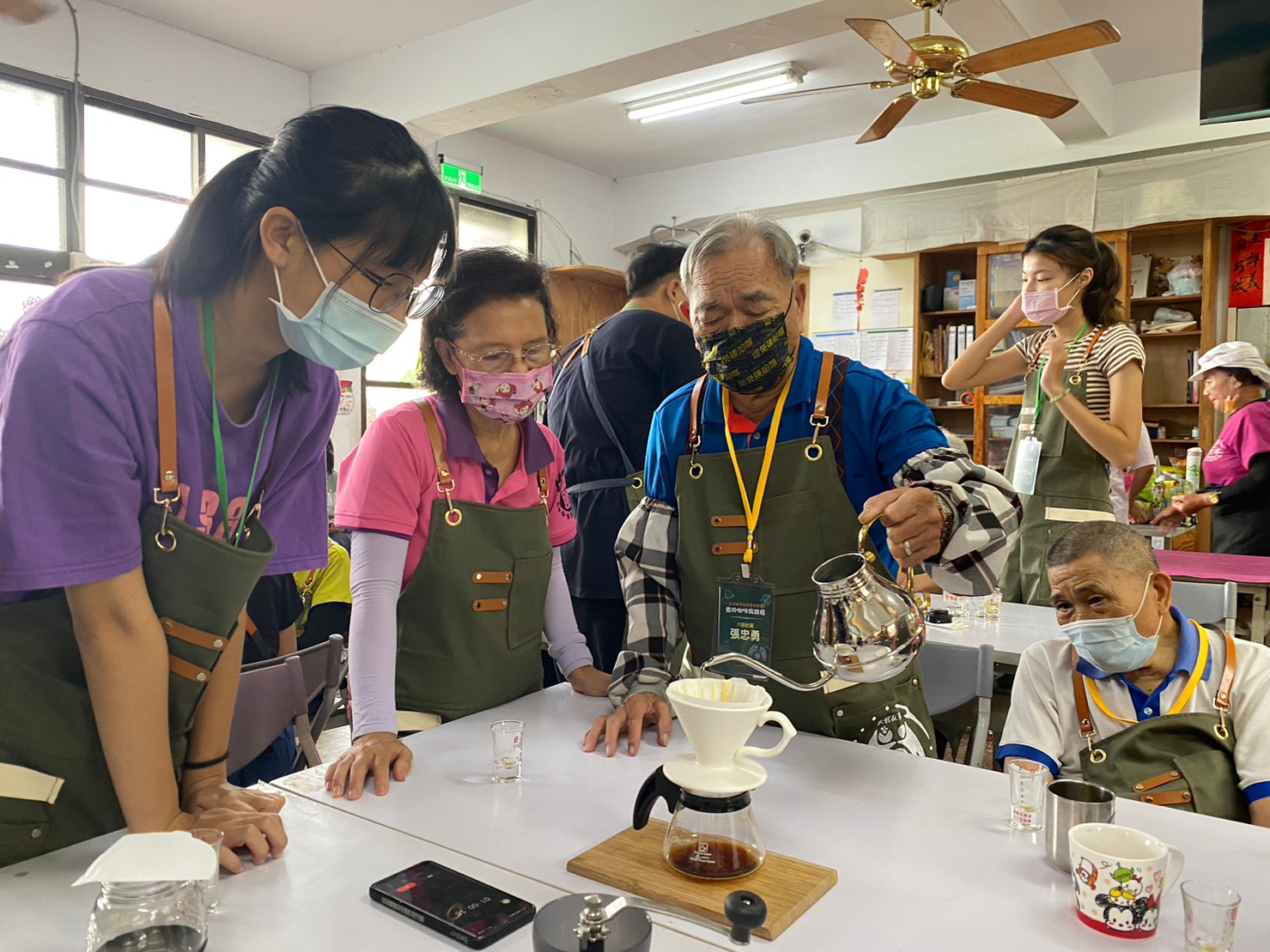 圖為六股社區長輩練習手沖咖啡，訓練手部穩定度。