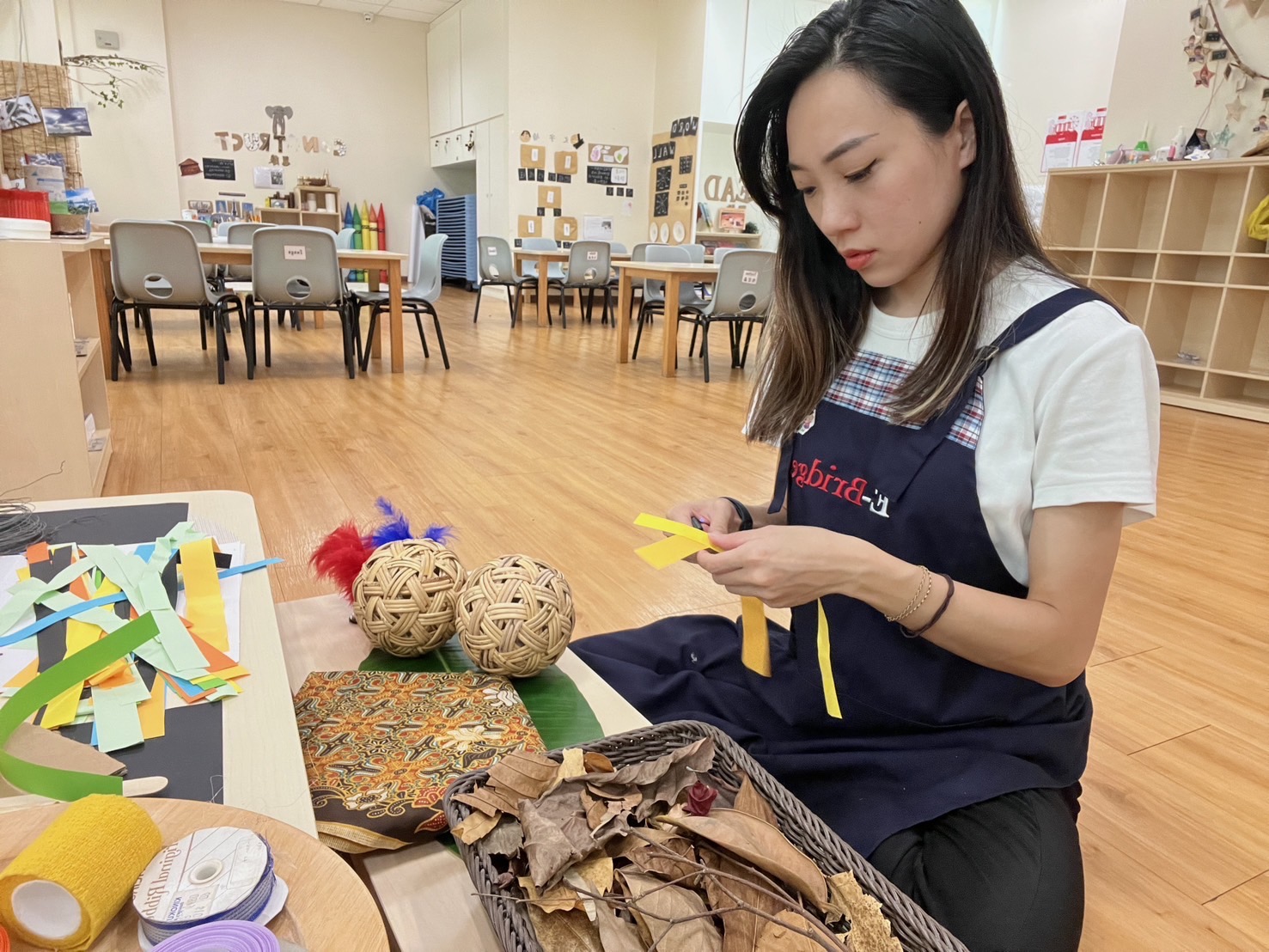 亞大幼教系畢業生林依儒，在新加坡伊橋幼兒園任教，於幼兒教育自然素材區備課情形。