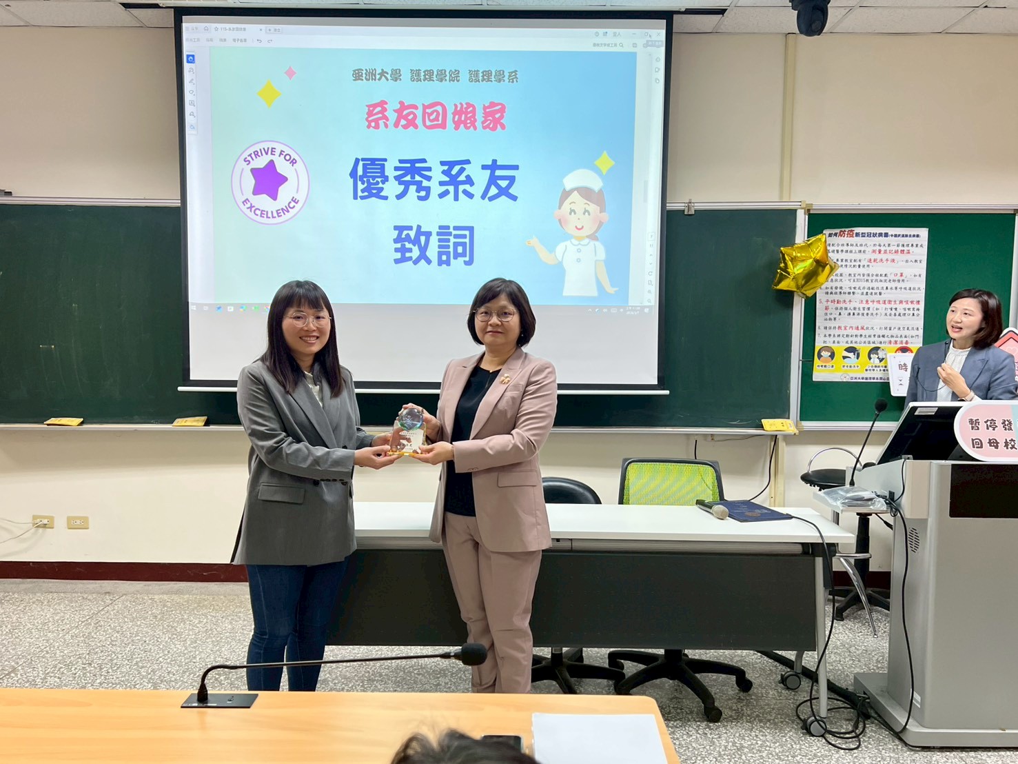 亞大護理學院院長兼護理學系主任吳樺姍（右）頒發傑出系友姚雅馨(左)獎座及獎狀，肯定其在臨床專業與學術發展上的傑出表現。