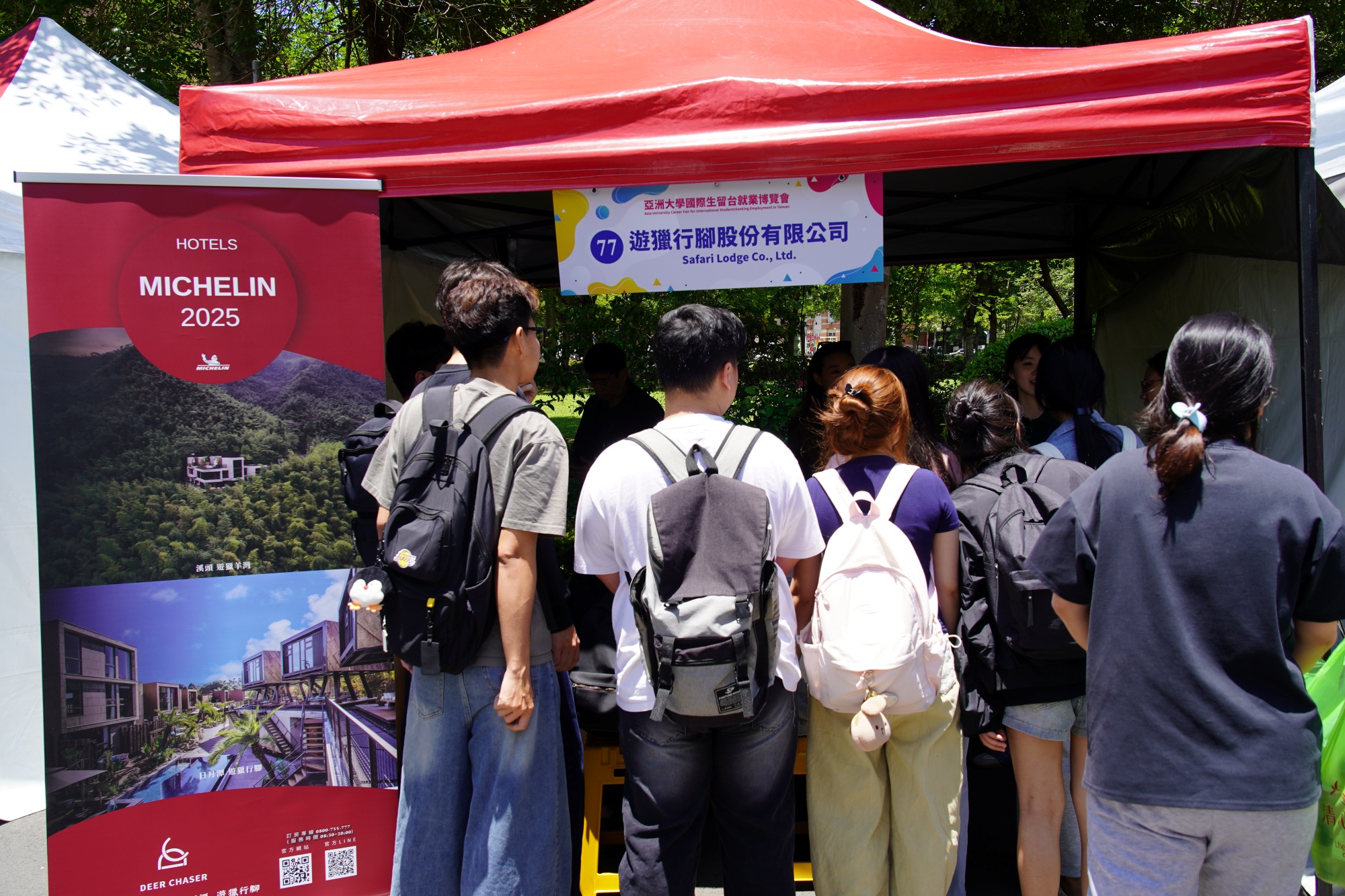 Students listen intently to employer presentations at the recruitment booths, proactively preparing for their future career development